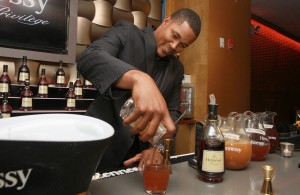 Familia mixes a drink at the Hennessy event.
