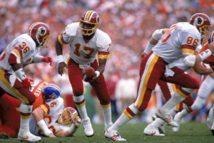 SAN DIEGO - JANUARY 31:  Quarterback Doug Williams #17 of the Washington Redskins prepares to hand of the ball to running back Timmy Smith #36 during Super Bowl XXII against the Denver Broncos at Jack Murphy Stadium on January 31, 1988 in San Diego, California.  The Redskins won 42-10.  (Photo by Mike Powell/Getty Images)