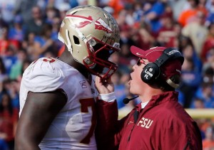 GAINESVILLE, FL - NOVEMBER 30:  Head coach Jimbo Fisher of the Florida State Seminoles grabs the facemask of Cameron Erving #75 during the game against the Florida Gators on November 30, 2013 in Gainesville, Florida.  (Photo by Sam Greenwood/Getty Images)
