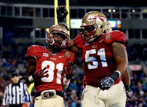 CHARLOTTE, NC - DECEMBER 07:  Wide receiver Kenny Shaw #81 celebrates a touchdown with offensive lineman Bobby Hart #51 of the Florida State Seminoles in the third quarter against the Duke Blue Devils during the ACC Championship game at Bank of America Stadium on December 7, 2013 in Charlotte, North Carolina.  (Photo by Streeter Lecka/Getty Images)