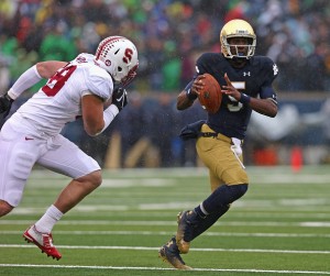 SOUTH BEND, IN - OCTOBER 04:  Everett Golson #5 of the Notre Dame Fighting Irish is pursued by Kevin Anderson #48 of the Standford Cardinal at Notre Dame Stadium on October 4, 2014 in South Bend, Indiana. Notre Dame defeated Standford 17-14.  (Photo by Jonathan Daniel/Getty Images)