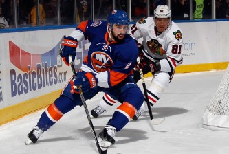 UNIONDALE, NY - DECEMBER 13: Nick Leddy #2 of the New York Islanders moves the puck past Marian Hossa #81 of the Chicago Blackhawks during the first period at the Nassau Veterans Memorial Coliseum on December 13, 2014 in Uniondale, New York. (Photo by Bruce Bennett/Getty Images)